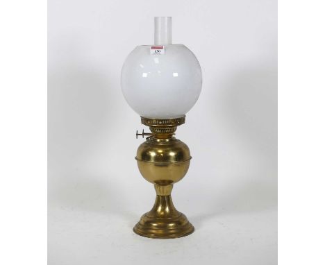 A Victorian brass oil lamp, having a milk glass shade, h.51cm