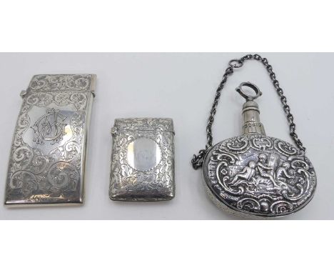 An Edwardian silver visiting card case of hinged rectangular form having foliate engraved decoration and monogram with gilt w