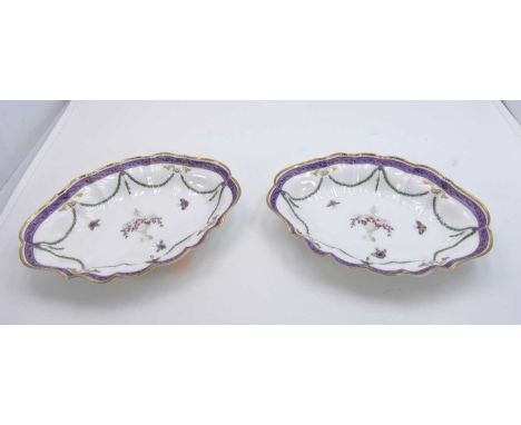 A pair of Royal Worcester porcelain dishes of shaped outline, decorated with urns and floral swags, width 25cmLight cutlery m