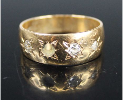 A 9ct gold diamond set half-hoop ring, arranged as four 'gypsy' set round cuts (one diamond missing), size N, 3.7g