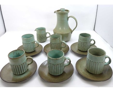 A Poole Pottery "New Stoneware" part coffee service, comprising of coffee pot, cream jug, six cups, and saucers, designed by 