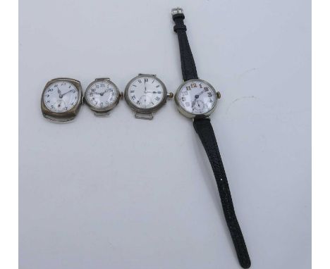 An early 20th century white metal cased trench type watch, having a circular enamel dial with Arabic numerals and outer track