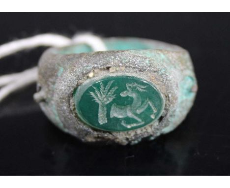 A Roman style bronzed metal and hardstone set signet ring, size W