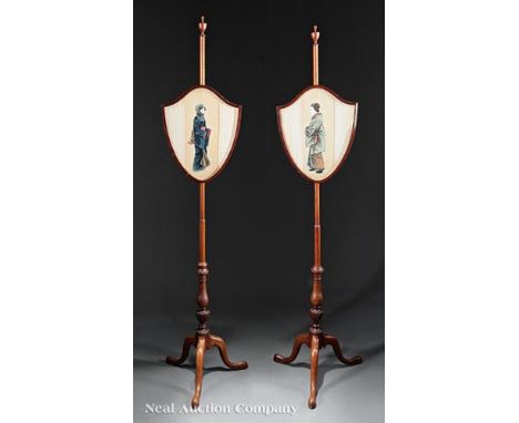 Pair of George III Carved Mahogany Pole Screens, 19th c., turned standard with urn finial, shield-shaped frame, arched legs, 