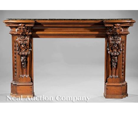 Antique Continental Carved Walnut Mantel, 19th c., granite shelf, stepped, blocked surround with grotesques, fruit and bellfl