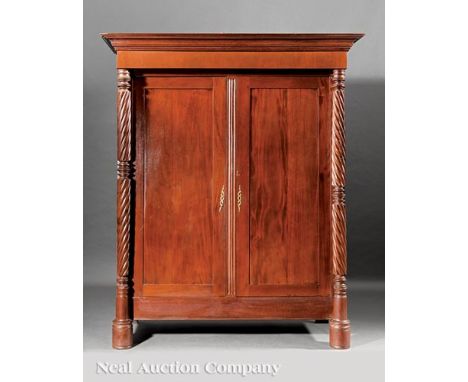 West Indies Carved Mahogany Armoire, 19th c., Trinidad, flared stepped cornice, paneled doors, fluted center stile, flanked b