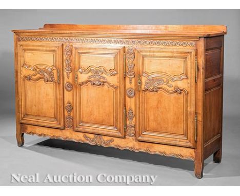 French Carved Fruitwood Buffet, 19th c., molded top with backsplash, floral-carved frieze, three paneled cabinet doors, shelf