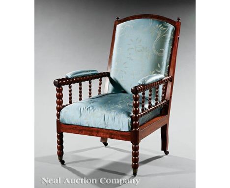 English Mahogany Library Armchair, mid-19th c., arched crest, padded back and seat, bobbin-turned arms and legs, casters, h. 