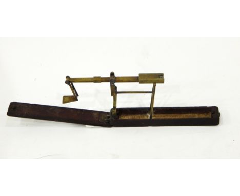 Pair of Georgian brass sovereign scales, the folding scales in mahogany case and bearing a paper label for "A Wilkinson, Orms