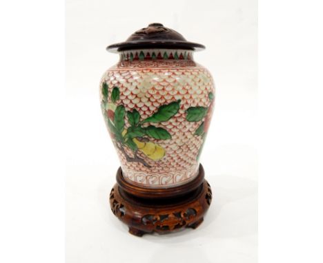 Chinese porcelain Wucai vase, baluster shaped, red scale ground, 14cm high with carved wooden lid and carved base (21cm overa