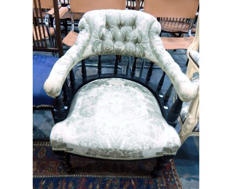 Ebonised and upholstered captain's chair with green floral fabric, on bobbin and tapering supports 