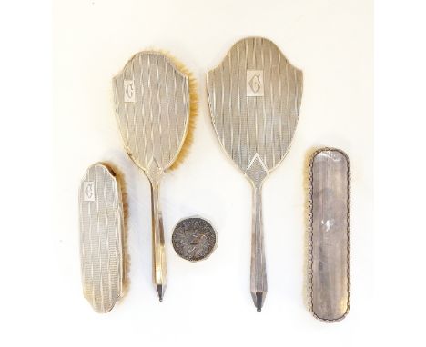 George V silver-backed part dressing table set comprising hand mirror, hairbrush and clothes brush, Birmingham 1932 together 