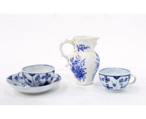 Royal Worcester moulded mask jug decorated with flowers in blue and white and a Meissen cup and saucer in the 'Onion' pattern
