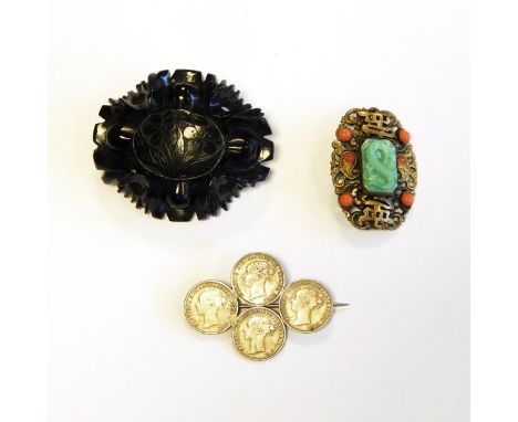 Carved jet brooch with floral engraved oval centre surrounded by deep carved border, Oriental gilt metal brooch set with jade