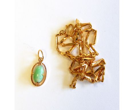 A jade and gold coloured pendant and the matching elongated twisted link chain necklace 