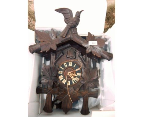 20th century oak cuckoo clock with floral decoration and bird finial to top