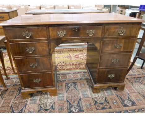 20th century mahogany veneer kneehole writing desk with an arrangement of nine drawers, on shaped bracket feet, 112cm wide 