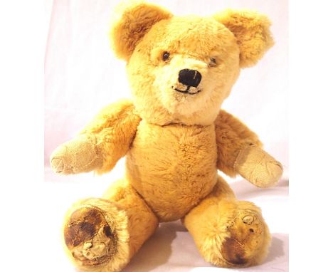 Vintage straw filled teddy bear, jointed arms and legs, pads on legs worn and bandages to both hands, H: 30 cm. P&amp;P Group