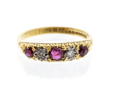 A ruby and diamond 18ct gold ring, set with three graduated round cut rubies, with alternate star set eight cut diamonds, dec