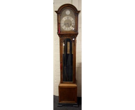 An early 20the century oak grandmother clock, the three train movement chiming upon gongs faced by 10'' Roman dial, over 3/4 