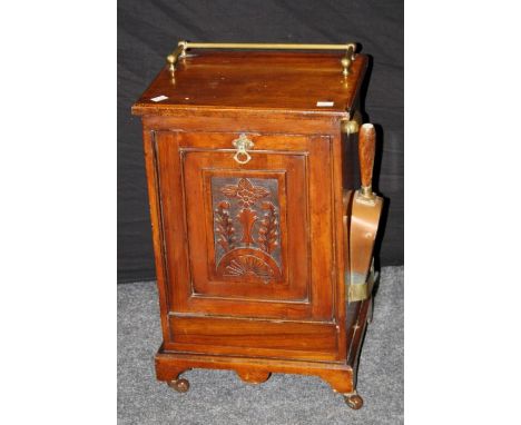 A late Victorian walnut coal purdonium with brass quarter gallery rail over florally carved fall front, with tin liner and sh