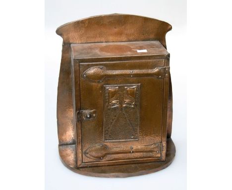 An Art Nouveau copper panel mounted hanging small wall cupboard, with embossed door height 43cm