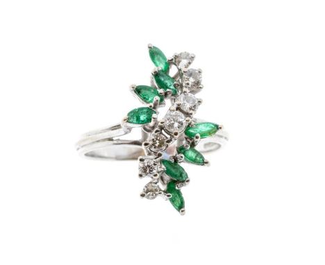 A diamond and emerald 18ct white gold cluster ring, comprising a central row of graduated round brilliant cut diamonds, total