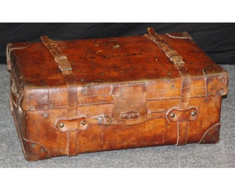 A large Edwardian stitched leather and brass studded cabin trunk, named O M Williams, 32 x 80 x 53cm&nbsp;