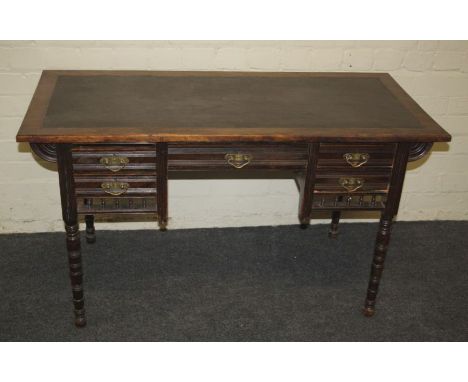 A late Victorian small writing table, the top with inset panel over one long and four short drawers, width 122cm