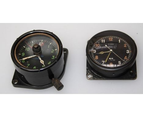 A cockpit clock in black composition case stamped A.M and another metal cased cockpit clock stamped A. M, diameter 6 and 6.5c