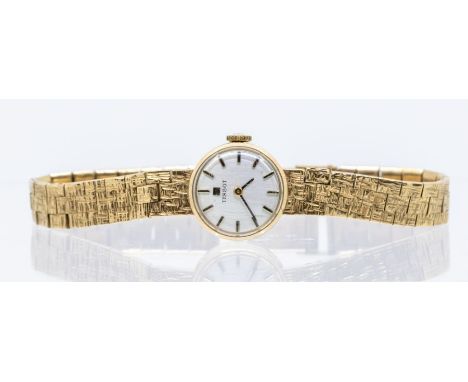 A 9ct gold&nbsp;ladies vintage&nbsp;Tissot&nbsp;&nbsp;wristwatch,&nbsp;round&nbsp;silvered dial with applied baton markers, a