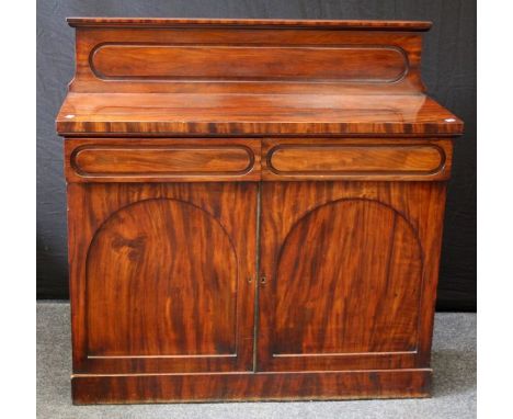 A 19th century mahogany chiffonier with panelled upstand over two frieze drawers and cupboard doors, on plinth, 116cm wide