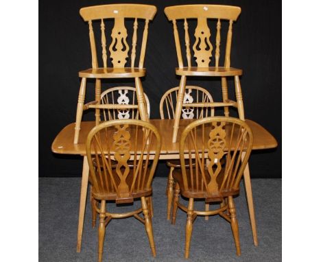 An Ercol style light elm extending dining table, the shaped rectangular top with single insert leaf on square spayed supports