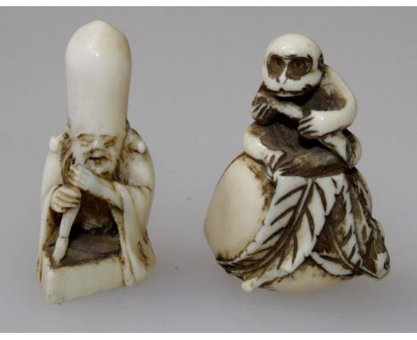 A 19th century ivory netsuke, carved as a monkey seated upon a gourd, 4cm, together with another of Shou Xing, 3.5cm