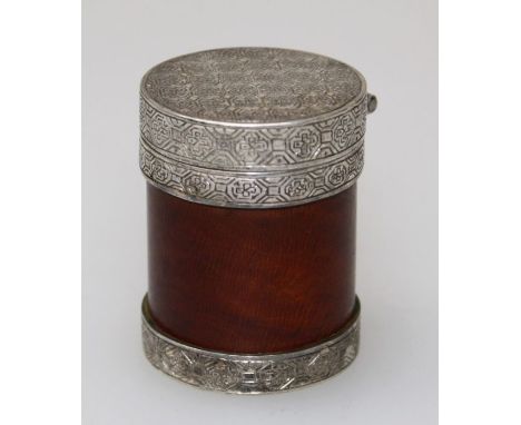 An early 20th century Japanese lacquered wood and silver mounted pill box of cylindrical form, the engine turned hinge cover 