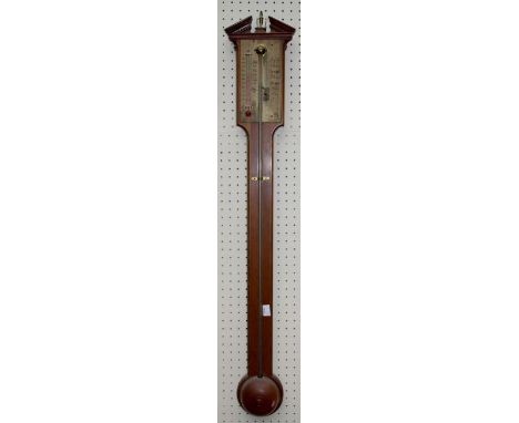 An 18th century style walnut cistern stick barometer having a brass register below a broken pediment, height 93cm