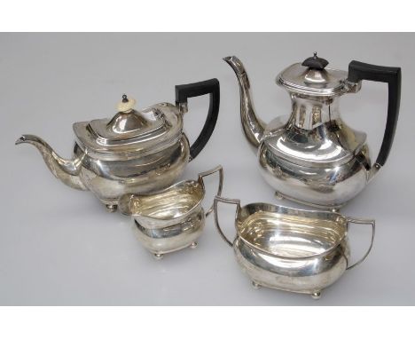Barker Brothers, a silver four piece tea service comprising tea and hot water pots, each with ebonized handle, angular twin h