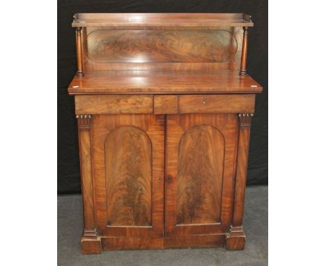 An early Victorian mahogany chiffonier, the shelved back over two frieze drawers and arched cupboard doors within square pila