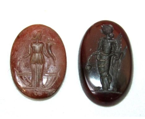 A Roman style oval carnelian Intaglio,, carved with portrait of  the Roman goddess Egeria, approx. 2 cm, together with a Gree