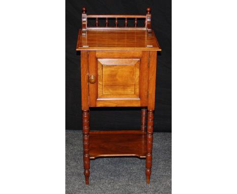 An Edwardian mahogany pot cupboard, the bobbin turned upstand over a fielded panel door, on ring turned supports united by un