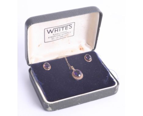 A three piece gold and amethyst set jewellery.