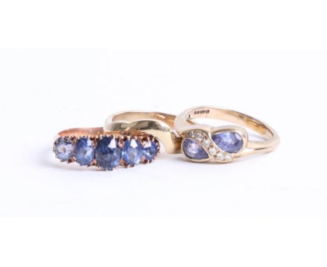 A 9ct gold tanzanite ring with 9ct gold band ring to match together with dress ring (3).