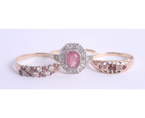 A collection of three dress rings including a pink stone cluster ring, and 9ct garnet set ring. (3).
