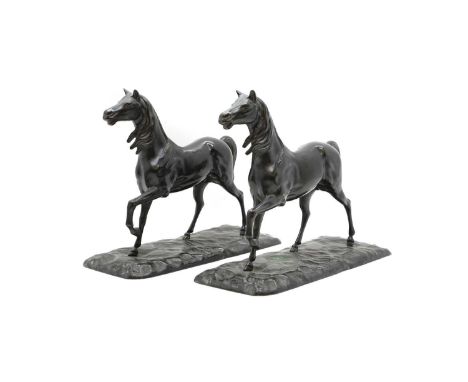 A pair of Arabian bronze horses in a trotting posture on naturalistic bases29cm highCondition ReportMinor scuffs to patinatio