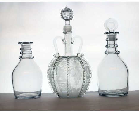 A glass decanter, c.1800, with three applied neck rings, below a bullseye stopper 28cm hightogether with a similar bottle lac