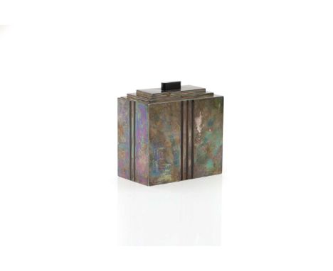 An Art Deco silver tea caddy,  c.1930, of rectangular form, with a stepped lid, complete with linear enamelled decoration, st