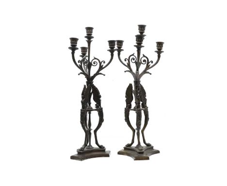 A pair bronze Regency style four light candelabra with winged figures on a triform base62cm highCondition ReportThe sconce se