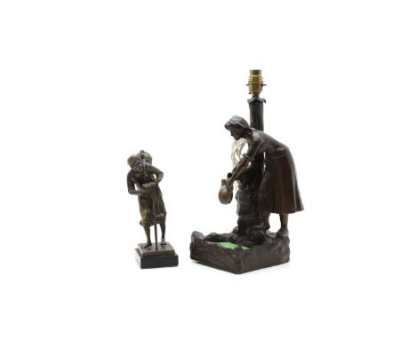After Paul Ludwig Kowlaczewski a bronze figure of a Middle Eastern beggar, signed,23.5cm hightogether with a spelter figure a
