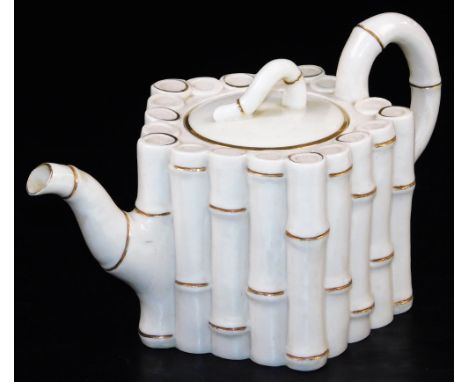 A first period Belleek bamboo moulded teapot and cover, black first period mark, the moulded body in the form of bamboo stems