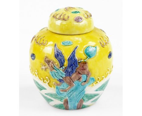 A Chinese porcelain ginger jar in the style of Wang Binrong, decorated in relief with a dog of fo seated on a rock among wave